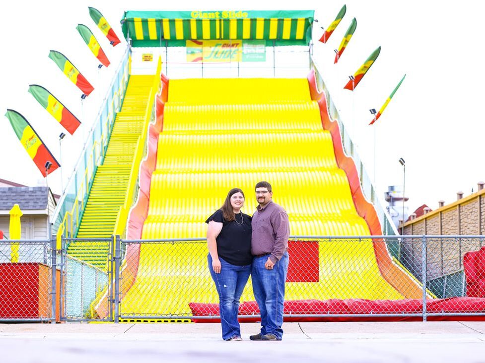 Man and woman in front of big slide